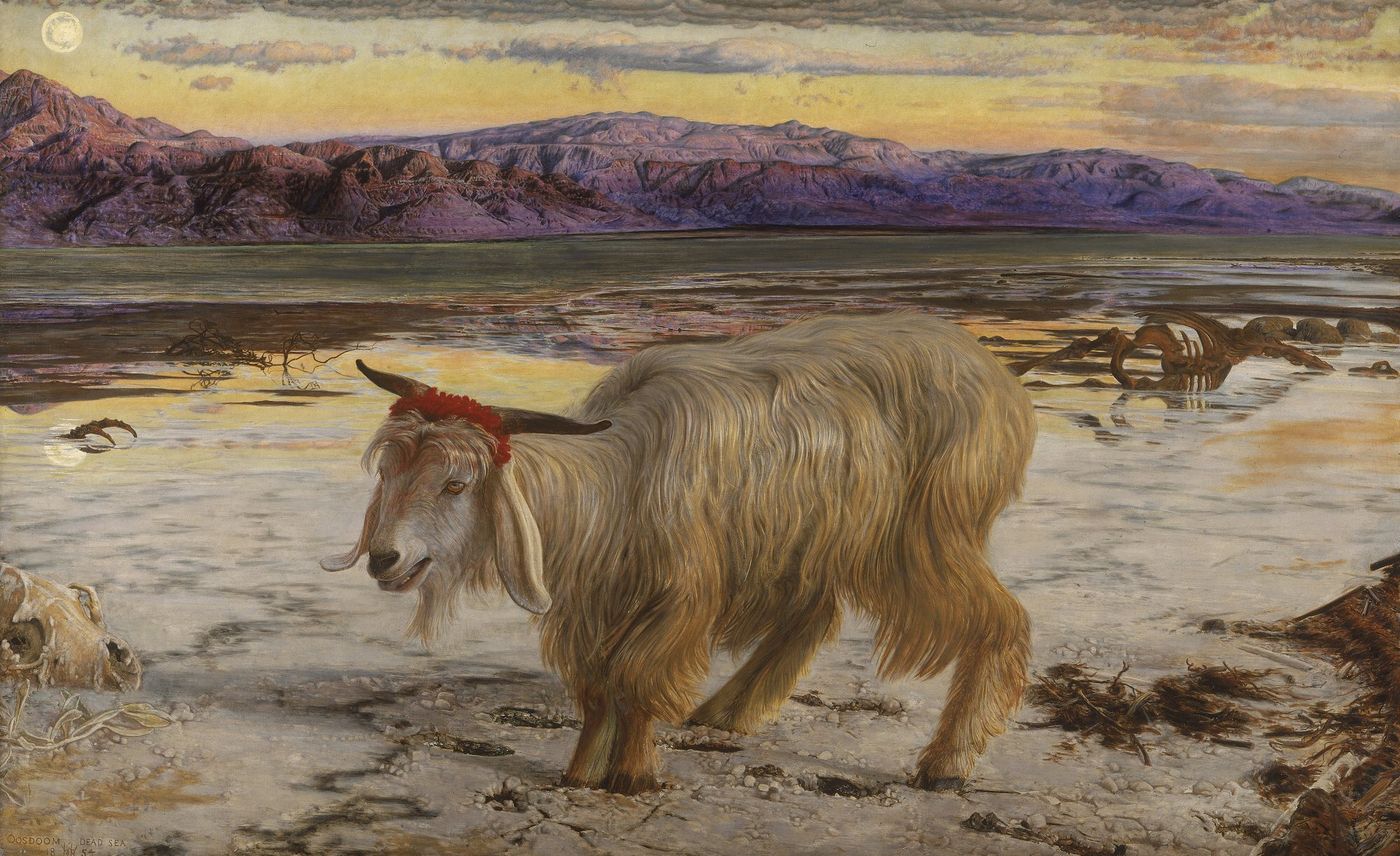 A long-haired, cream-colored goat with a red band around its horns stands on a pale, salt-crusted shore of the Dead Sea at dusk, with purple mountains and a small moon behind it and animal bones in the foreground.