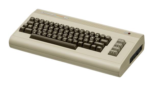 A beige Commodore 64 computer with brown keys and a rainbow-striped Commodore 64 nameplate, photographed from a three-quarter angle against a white background.
