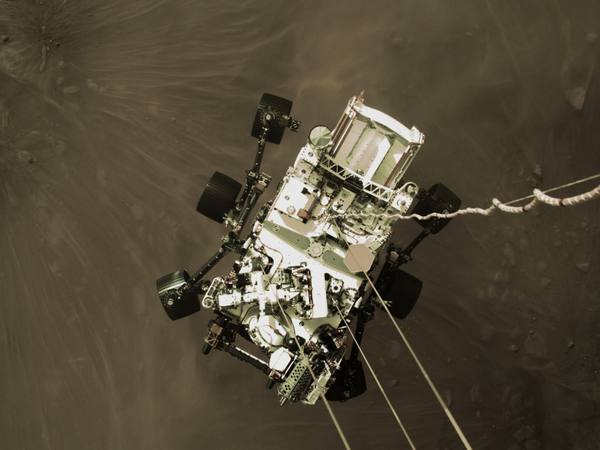 A camera aboard the descent stage captured this view of NASA's Perseverance rover as it touched down on Mars on February 18, 2021.