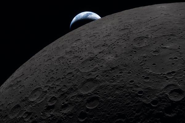 Earth sets behind the cratered lunar surface in this view captured through an Orion spacecraft window at 6:41 p.m. EDT on April 6, 2026, during the Artemis II crew's flyby of the Moon.