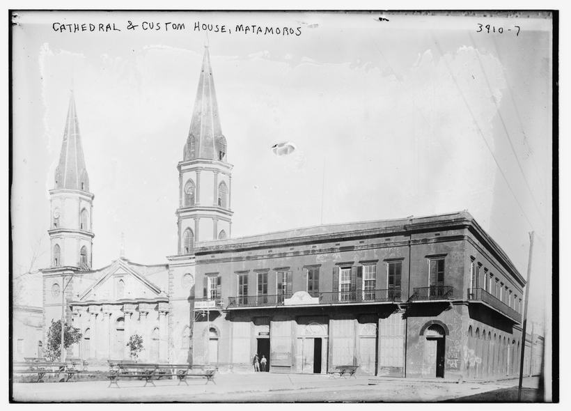 1915 photograph of the twin-spired cathedral and the custom house on a Matamoros street corner