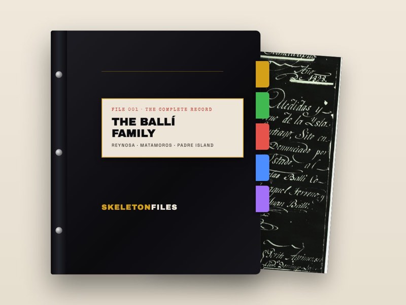 A dark family binder with a labeled spine and colored tabs, a manuscript page showing at the edge