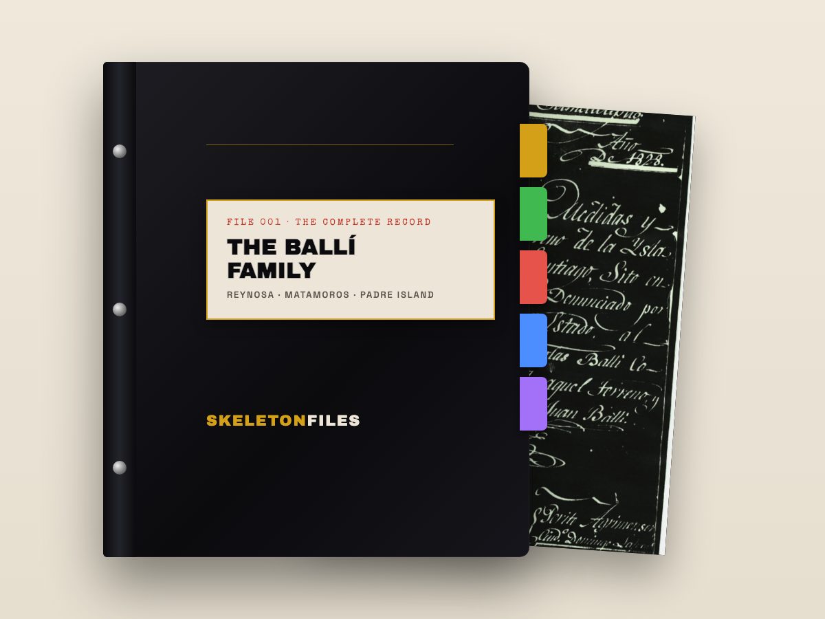 A dark family binder with a labeled spine and colored tabs, a manuscript page showing at the edge
